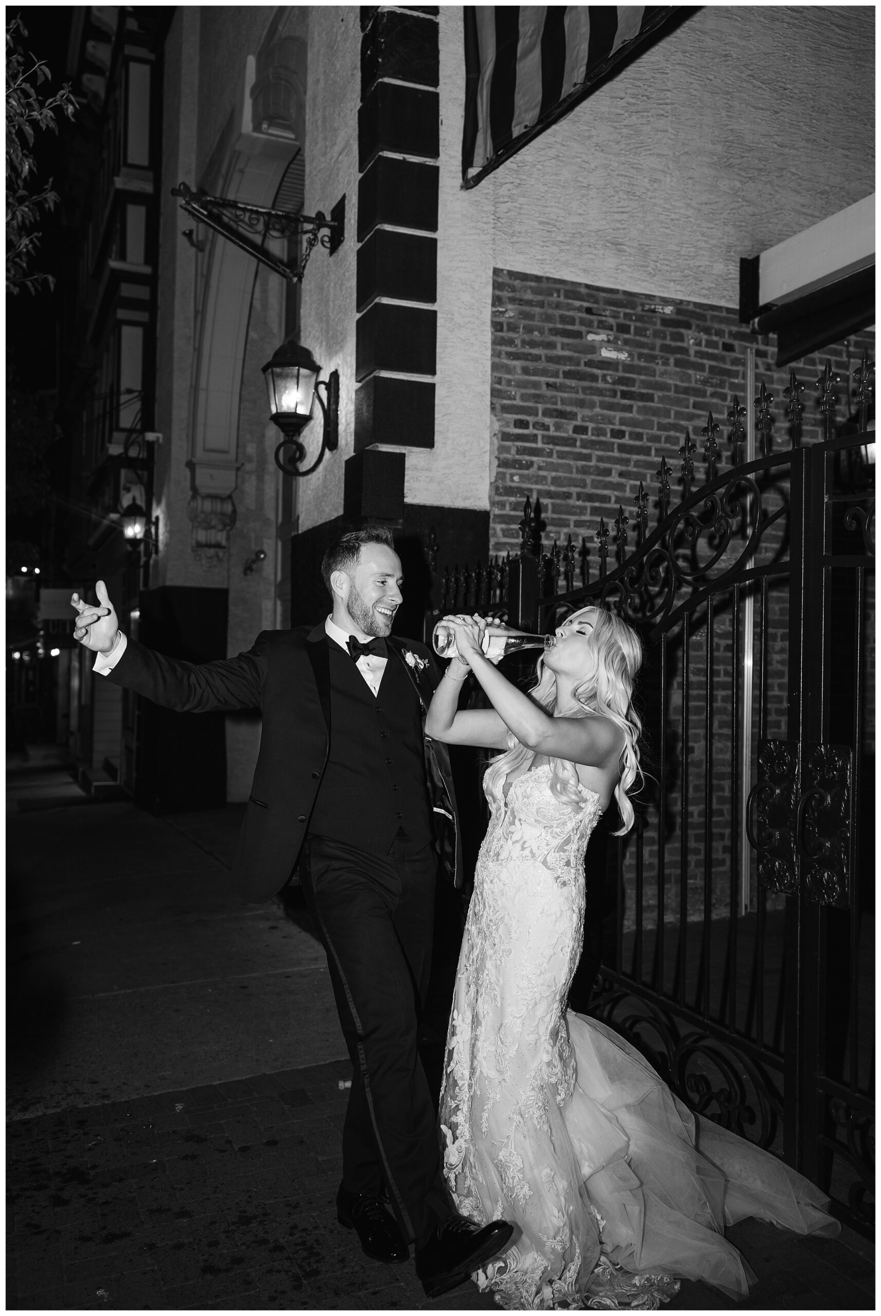 direct flash image of bride and groom drinking champagne outside the Cescaphe Ballroom in Philadelphia.